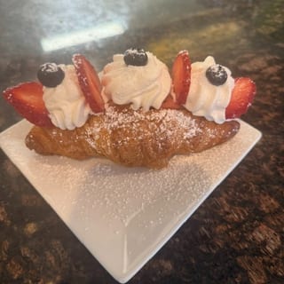 Strawberries whipped cream croissant