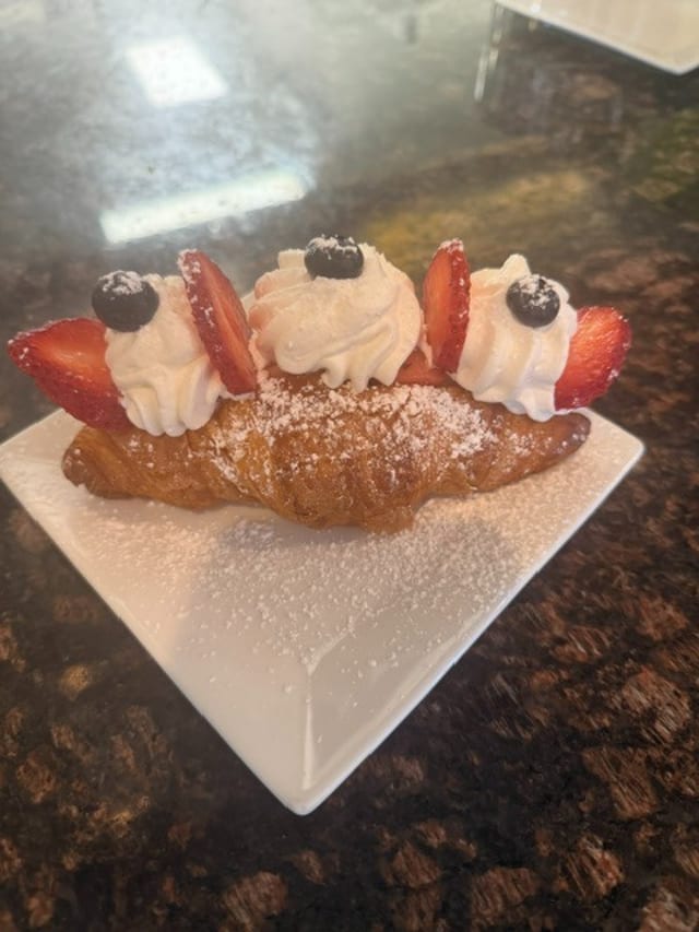 Strawberries whipped cream croissant.